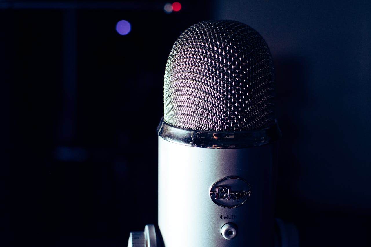 services-02 Dynamic photo of a condenser microphone in a dimly lit studio, perfect for podcasts.